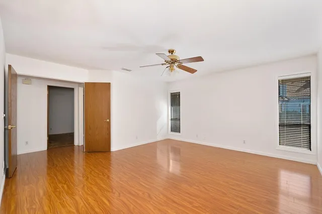 a bathroom with a granite countertop sink a toilet a mirror and shower