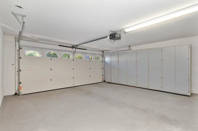 a view of a chair and table on the side of the house