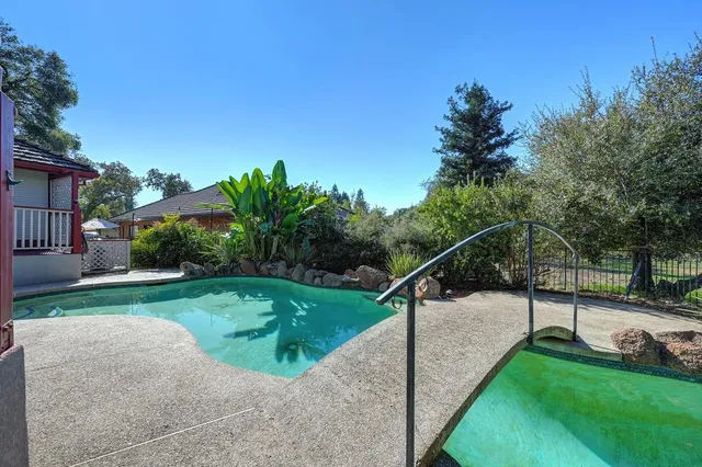 a view of a house with a yard and sitting area