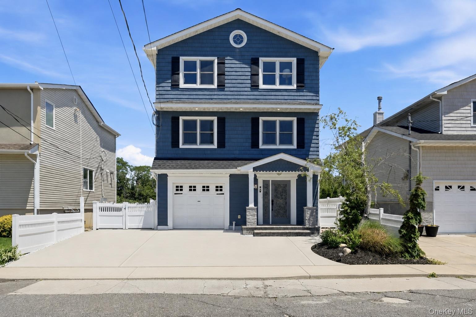 35 Redfield Road Island Park, NY 11558 - Photo 1 of 50 Three-story residence featuring blue siding with white trim and black shutters