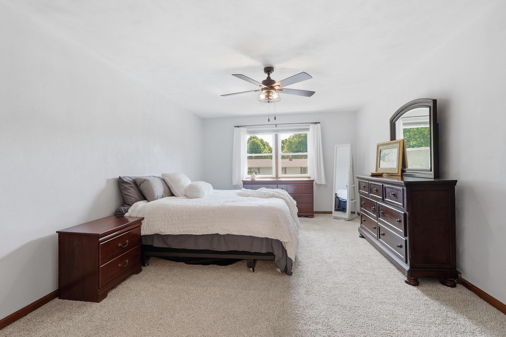 4314 Spring Street Davenport, IA 52807 - Photo 28 of 51 a spacious bedroom with a bed and a chandelier