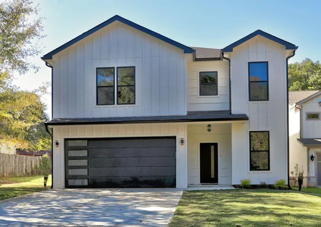 a view of a hallway with wooden floor and a living room