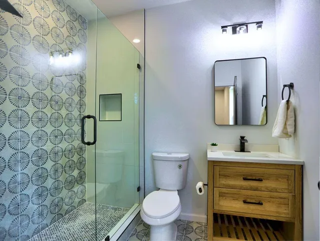 a kitchen with stainless steel appliances granite countertop a table chairs refrigerator microwave and cabinets