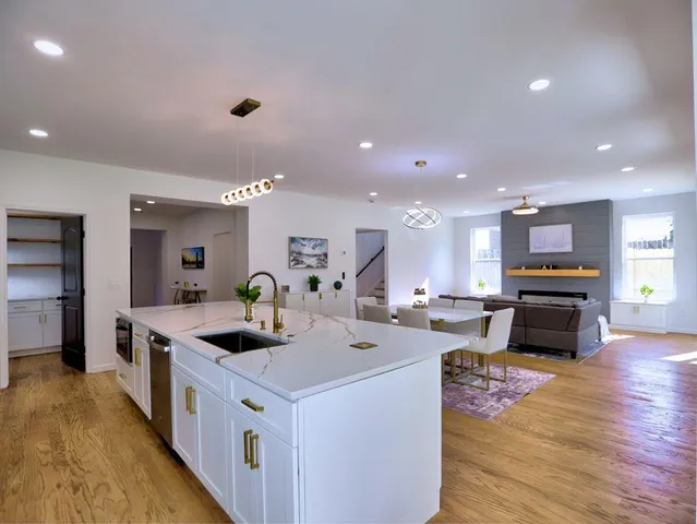 a large kitchen with stainless steel appliances a lot of counter space and wooden floor