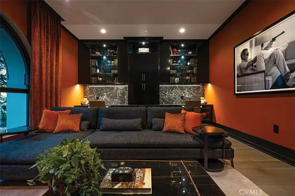 a living room with furniture a floor to ceiling window and a flat screen tv