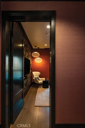 a bedroom with a large bed and a flat tv screen