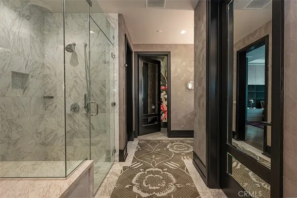 a view of walk in closet with clothes and shoes