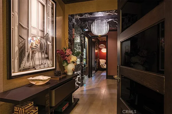 a view of entryway and hall with wooden floor