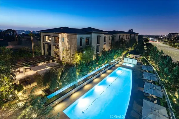 a view of a patio with chairs and a small yard