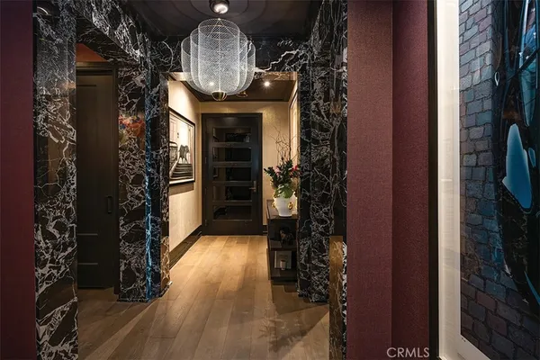 a view of a white building among the street and palm trees