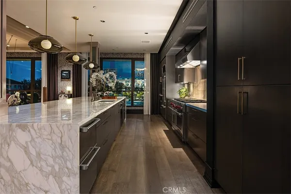 a kitchen with a sink a stove and chairs