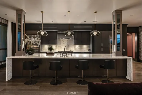 a kitchen with stainless steel appliances kitchen island granite countertop a sink and a stove