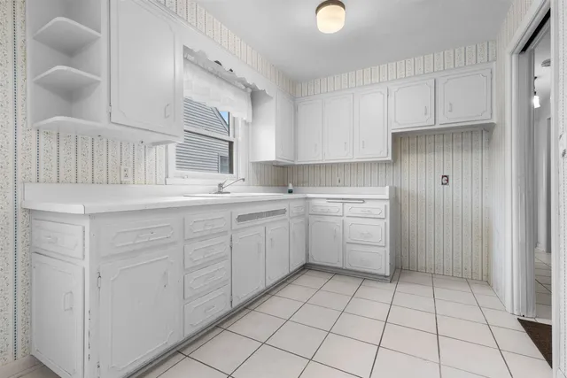a kitchen with a sink cabinets and window