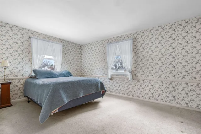 a spacious bedroom with a bed and a window