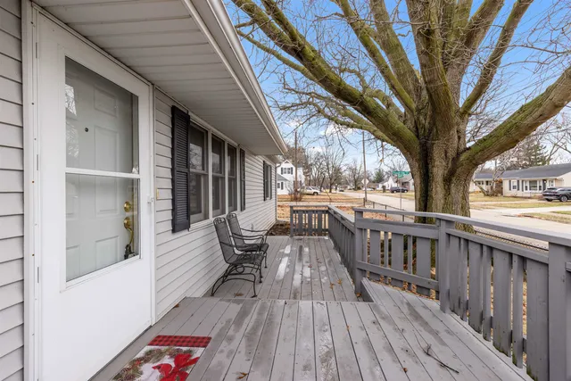 a view of balcony with chairs and wooden fence