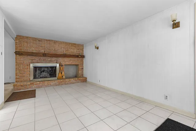 a view of an empty room with a fireplace