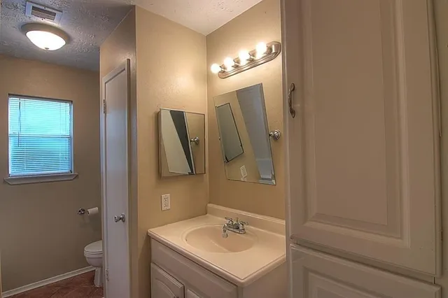 a bathroom with a sink vanity and a mirror