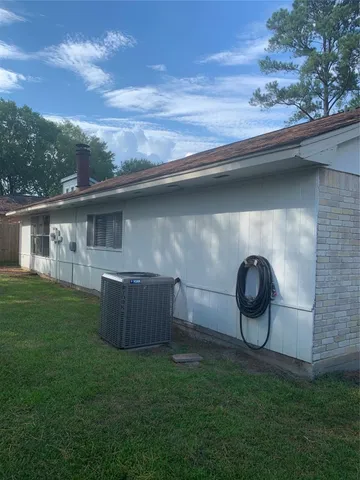 a backyard of a house with table and chairs