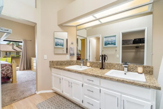 a spacious bathroom with double sink and a mirror