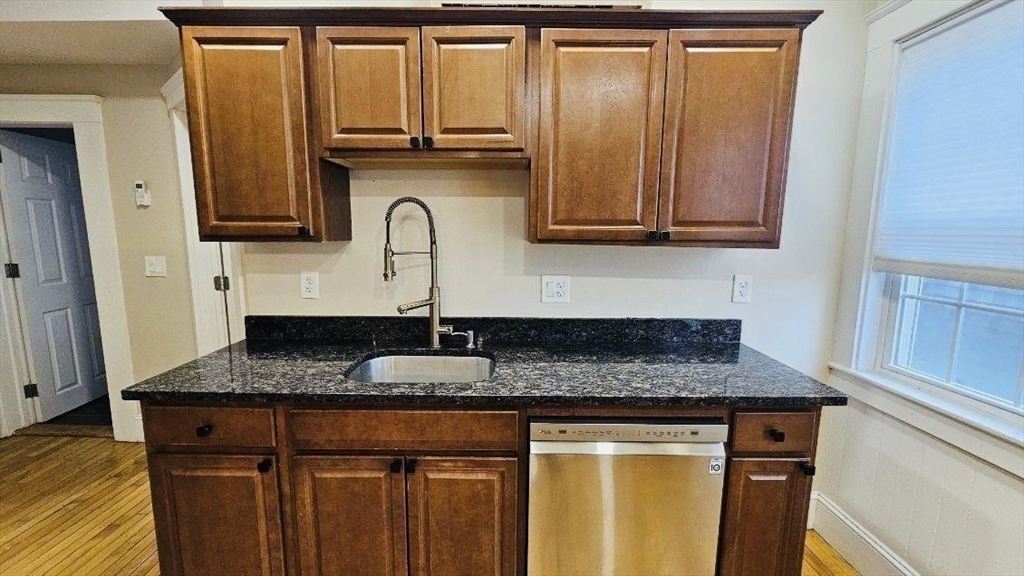 132 North Street, Unit 3 Salem, MA 01970 - Photo 18 of 19 a kitchen with granite countertop cabinets and stainless steel appliances