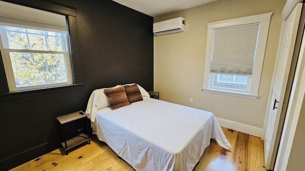 132 North Street, Unit 3 Salem, MA 01970 - Photo 19 of 19 a bedroom with a bed and wooden floor