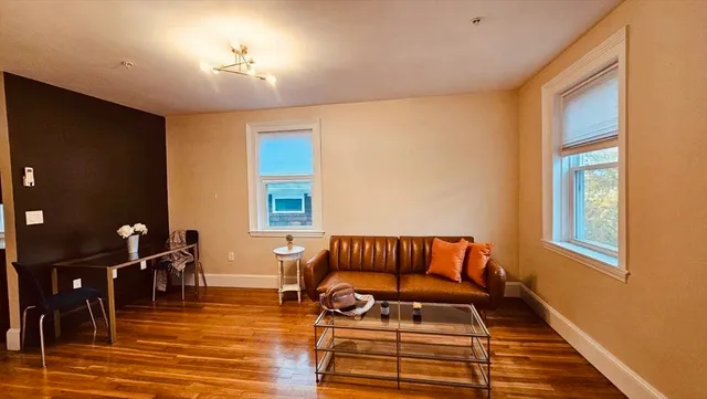 a room with wooden floor and furniture