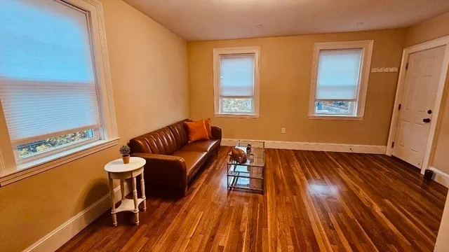 a room with wooden floor and furniture