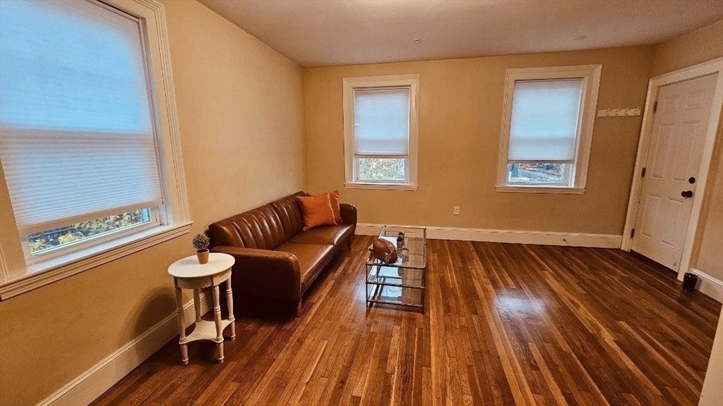 132 North Street, Unit 3 Salem, MA 01970 - Photo 5 of 19 a room with wooden floor and furniture