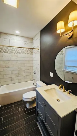 a bathroom with a double vanity sink toilet mirror and shower