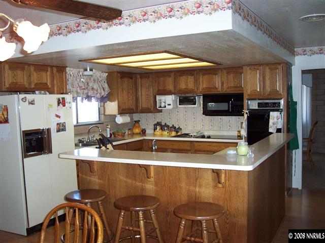 1455 Sioux Trail Reno, NV 89521 - Photo 2 of 9 a kitchen with stainless steel appliances granite countertop a sink a stove and a refrigerator