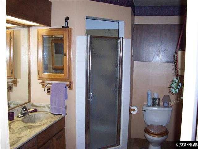 1455 Sioux Trail Reno, NV 89521 - Photo 8 of 9 a bathroom with a granite countertop sink toilet and shower
