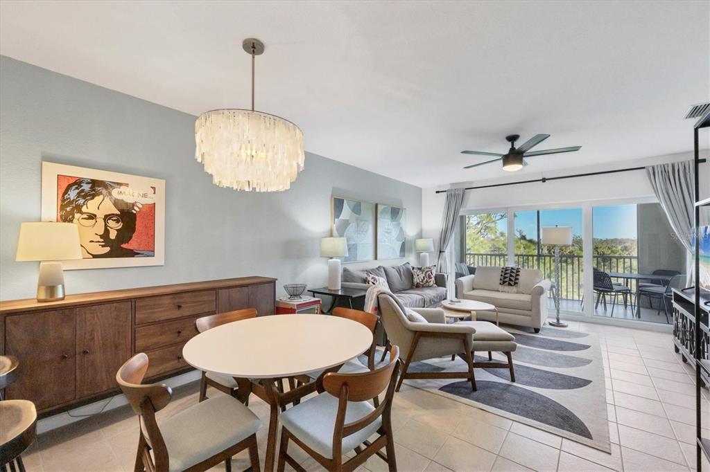 8407 Placida Road, Unit 307 Placida, FL 33946 - Photo 15 of 50 a view of a dining room with furniture wooden floor and chandelier