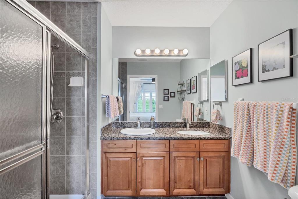 8407 Placida Road, Unit 307 Placida, FL 33946 - Photo 21 of 50 a bathroom with granite countertop a sink and a mirror