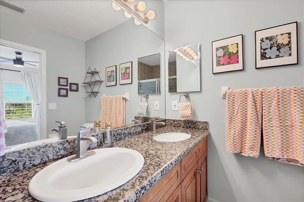 8407 Placida Road, Unit 307 Placida, FL 33946 - Photo 22 of 50 a bathroom with a granite countertop sink and a mirror