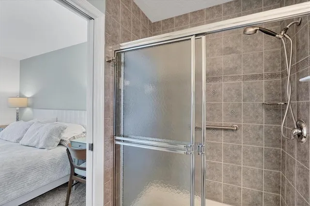 a bed room with a bed and a chair