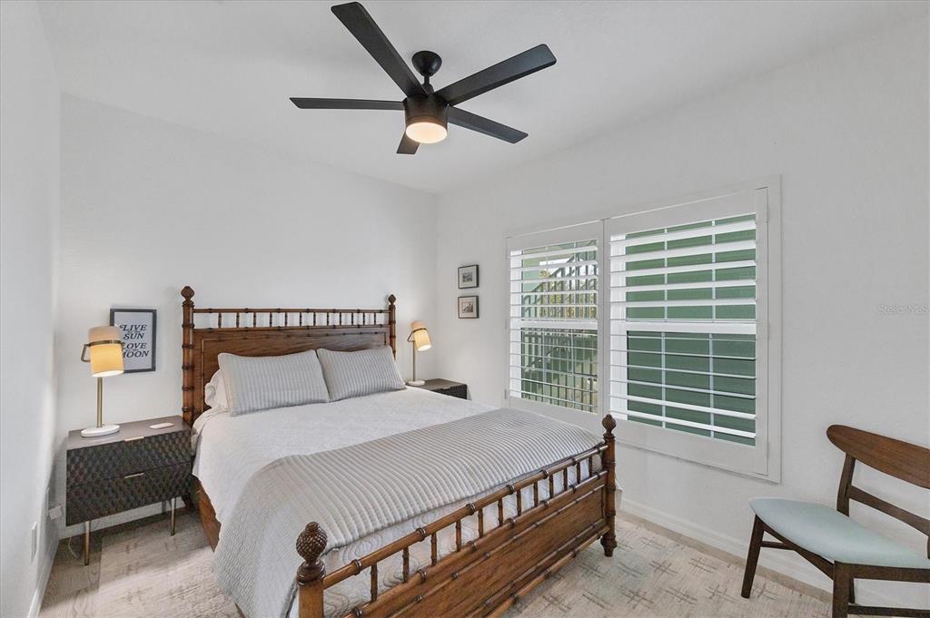 8407 Placida Road, Unit 307 Placida, FL 33946 - Photo 24 of 50 a bed room with a bed and a chair