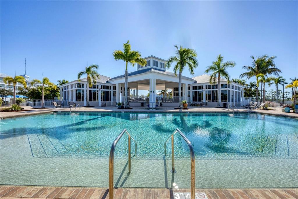 8407 Placida Road, Unit 307 Placida, FL 33946 - Photo 41 of 50 a view of a swimming pool with a garden and plants