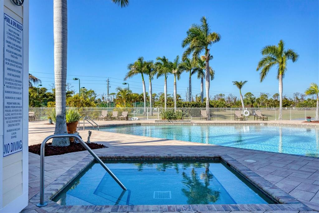 8407 Placida Road, Unit 307 Placida, FL 33946 - Photo 42 of 50 a view of a swimming pool with a lounge chairs