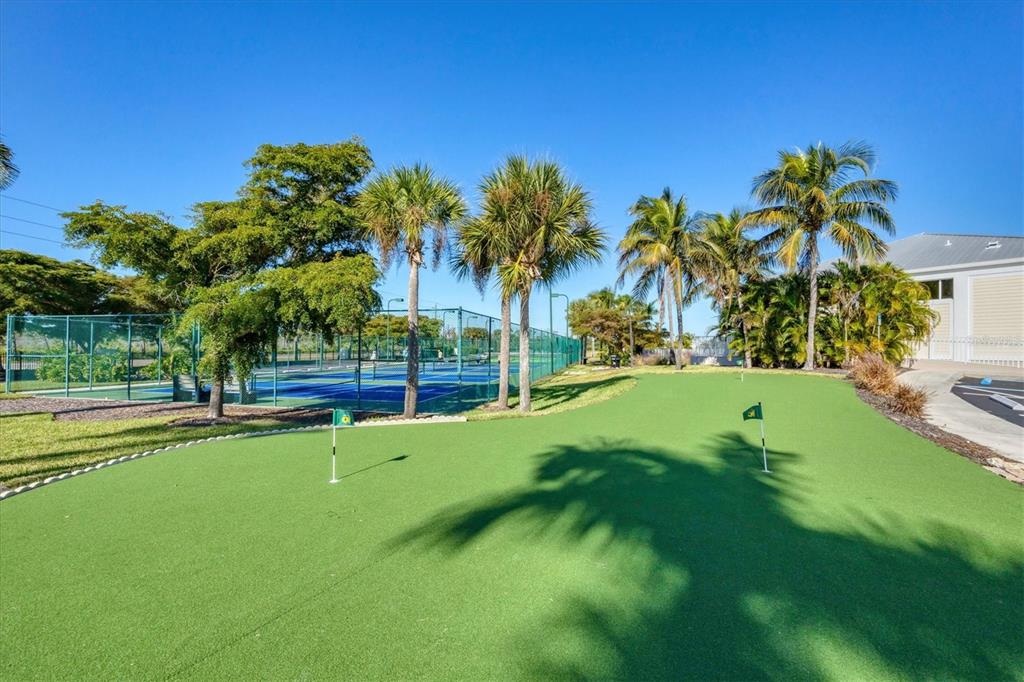 8407 Placida Road, Unit 307 Placida, FL 33946 - Photo 45 of 50 a view of a swimming pool with a yard