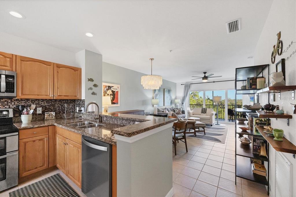 8407 Placida Road, Unit 307 Placida, FL 33946 - Photo 5 of 50 a kitchen with a stove a sink a refrigerator and cabinets