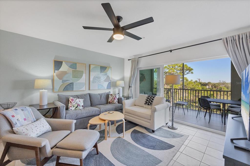 8407 Placida Road, Unit 307 Placida, FL 33946 - Photo 8 of 50 a living room with furniture a ceiling fan and a large window