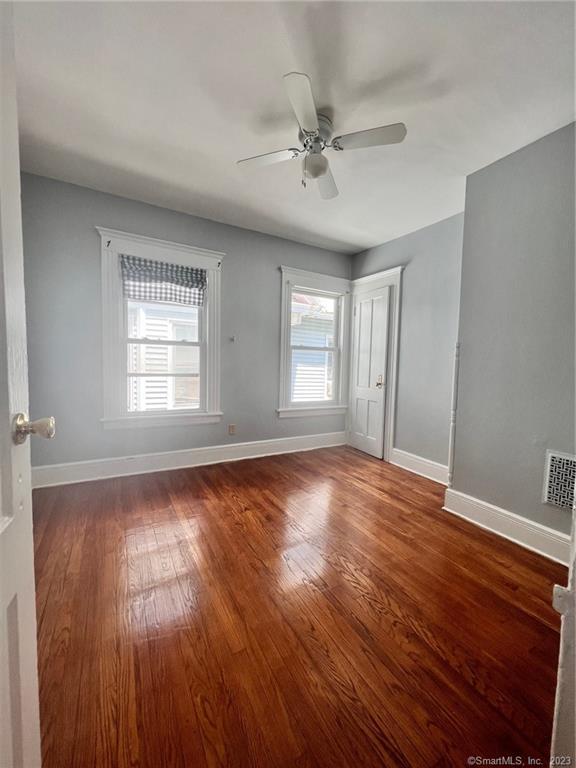 819 William Street, Unit 2 Bridgeport, CT 06608 - Photo 2 of 11 a view of an empty room with wooden floor and a window