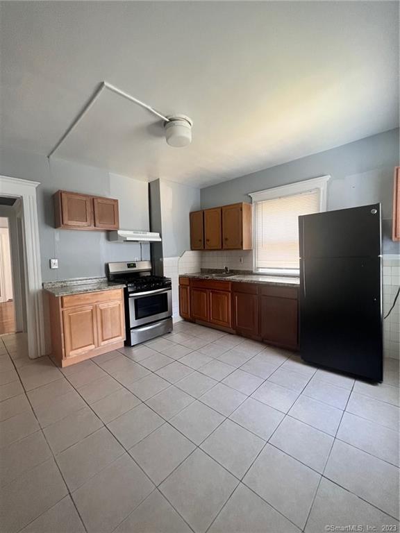 819 William Street, Unit 2 Bridgeport, CT 06608 - Photo 5 of 11 a kitchen with stainless steel appliances granite countertop a refrigerator and a stove top oven