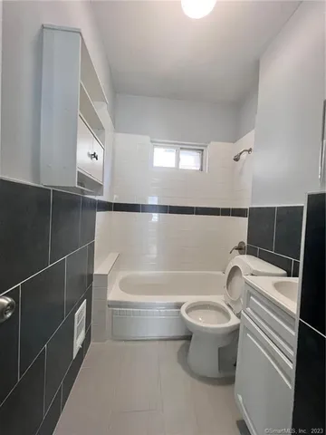 a bathroom with a toilet and a bathtub