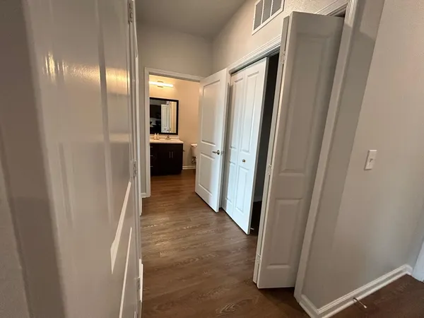 a view of a hallway with wooden shelves