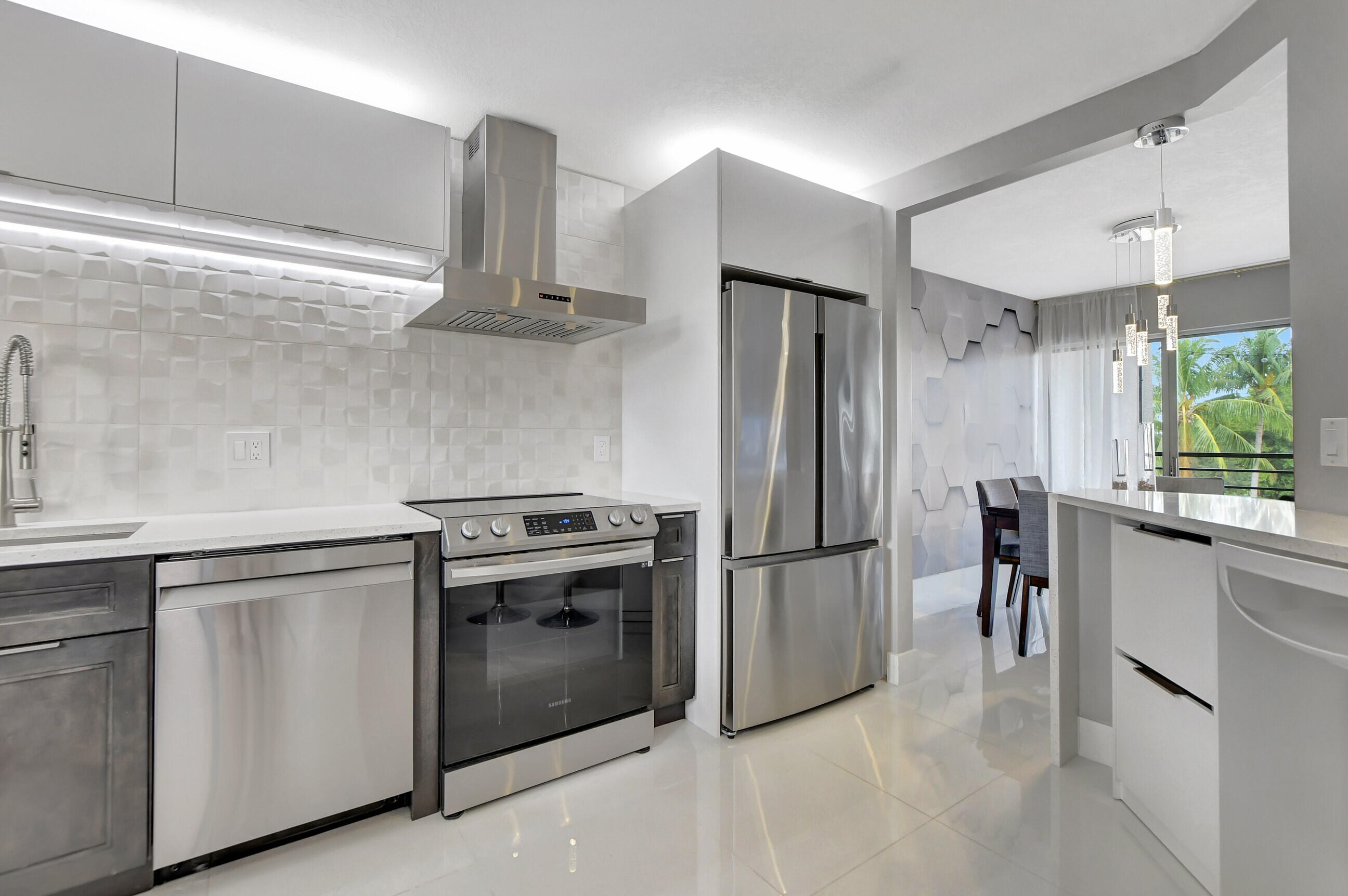 a kitchen with stainless steel appliances a stove and a refrigerator