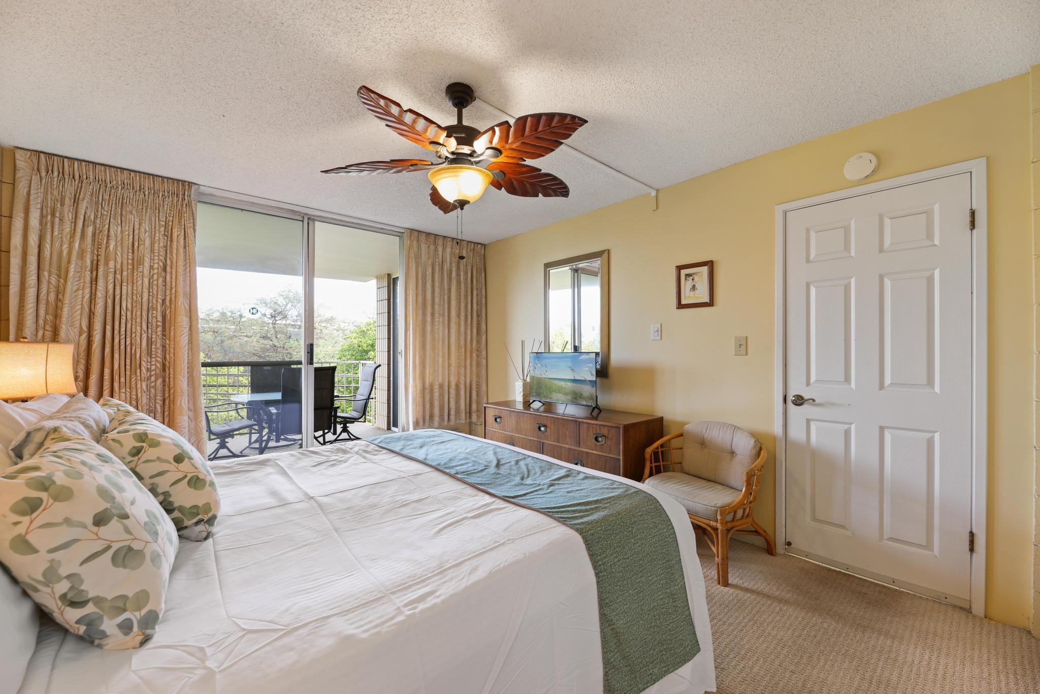 2619 South Kihei Road, Unit A305 Kihei, HI 96753 - Photo 14 of 44 a bedroom with a bed and a chandelier