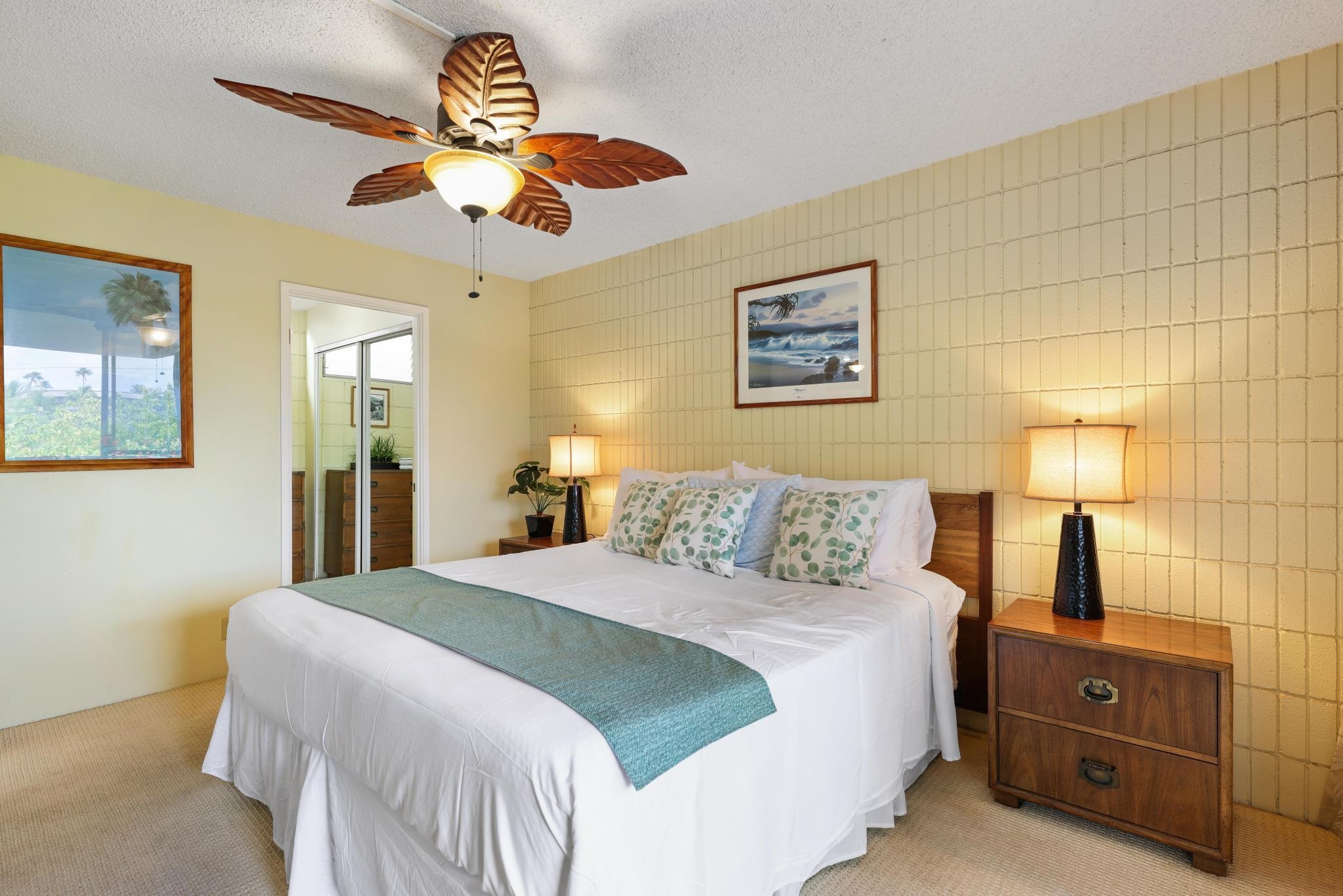 2619 South Kihei Road, Unit A305 Kihei, HI 96753 - Photo 16 of 44 a bedroom with a bed and a chandelier