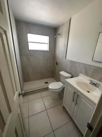 a bathroom with a toilet sink and window