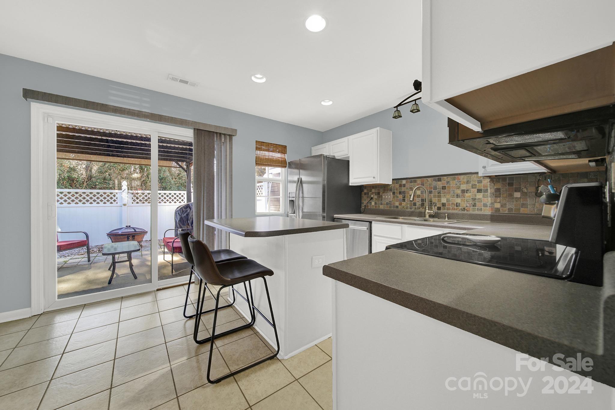 8134 Rudolph Road Charlotte, NC 28216 - Photo 13 of 27 a kitchen with stainless steel appliances kitchen island granite countertop a sink and a stove
